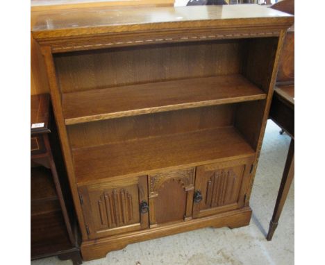 Reproduction oak Old Charm style bookcase on bracket feet.(B.P. 24% incl. VAT)