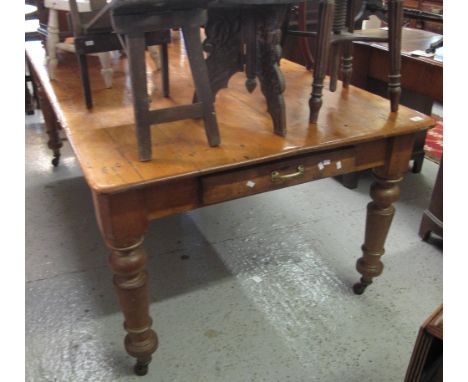 19th Century stripped pine kitchen table with end drawer, on baluster turned legs with ceramic casters.(B.P. 24% incl. VAT)  