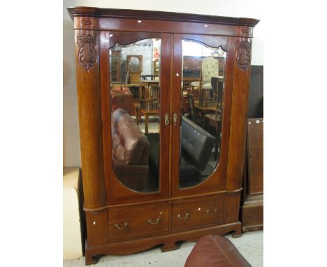 Early 20th Century mahogany double mirror door wardrobe with moulded and carved lyre panels, two drawers below on bracket fee