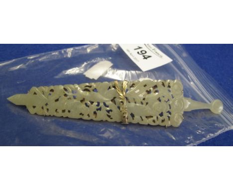 Carved and pierced jade bar brooch in the form of a dagger in yellow metal setting.(B.P. 24% incl. VAT)   CONDITION REPORT:  