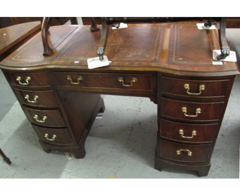 Reproduction mahogany pedestal kneehole writing desk with inset leather surfaces and cock beaded drawers on bracket feet.(B.P