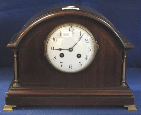 Early 20th Century two train mahogany arched mantel clock with enamel face, brass pillars and brass feet, French brass drum m