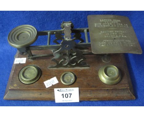 Set of brass postal scales on moulded oak base with some weights.(B.P. 24% incl. VAT)