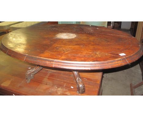 Cut down Victorian walnut oval loo table on quatraform base with ceramic casters.(B.P. 24% incl. VAT)