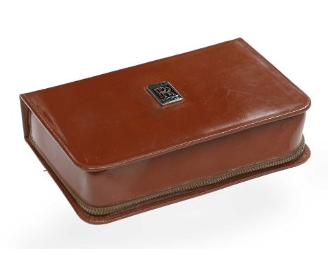 A Rolls-Royce Gentleman's Travel Set, mid 20th century, the case with chromed badge enclosing brushes, jars, a razor and othe