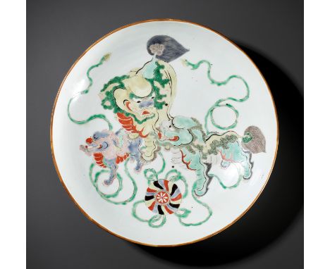 A LARGE FAMILLE VERTE 'BUDDHIST LIONS' DISH, KANGXI PERIODChina, 1661-1722. Sturdily potted, the rounded sides rising from a 