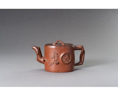 A MOULDED YIXING ZISHA 'THREE FRIENDS OF WINTER' TEAPOT AND COVER, 20TH CENTURYChina. Of brown clay, the teapot molded as a t