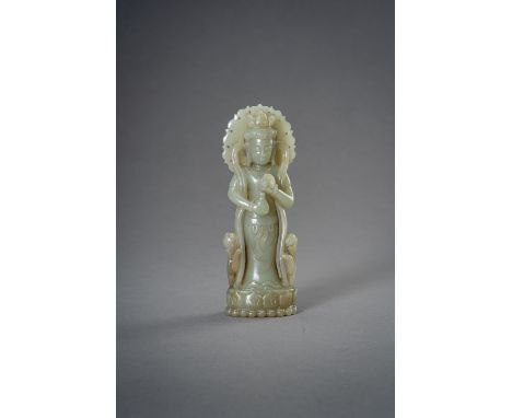 A CELADON JADE FIGURE OF GUANYIN, 1930sChina, Republic period (1912-1949). Carved standing on a lotus base, dressed in a dhot