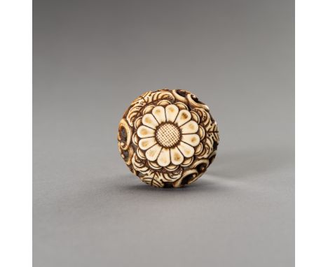 AN IVORY RYUSA MANJU NETSUKE WITH KIKU BLOSSOMSUnsignedJapan, 19th centuryFinely carved in openwork and stained with a formal