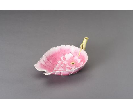 A FAMILIE ROSE ENAMELED PORCELAIN 'LOTUS' LIBATION CUP, DATED 1884China, Guangxu period (1875-1908), dated 1884. Molded in th