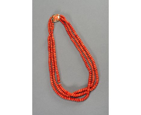 A THREE-TIERED MOMO CORAL BEAD NECKLACEJapan for the Tibetan market, mid-20th century. The necklace with three strings, compo