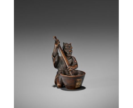 SHOKO: A WOOD NETSUKE OF AN ONI STIRRING MISOBy Shoko Sugunoya, signed Shoko 尚古Japan, Takayama, Hida school, mid-19th century