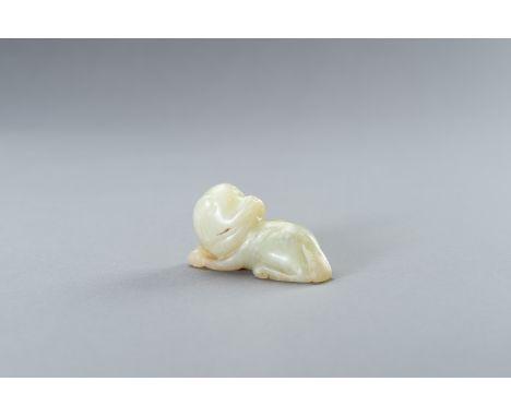 A PALE CELADON JADE FIGURE OF A DOGChina, late Qing Dynasty (1644-1912) to Republic period (1912- 1949). The recumbent dog de