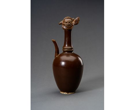 A PERSIMMON-GLAZED CHICKEN-HEAD PORCELAIN EWERChina, Qing dynasty (1644-1912) or earlier. The ovoid body rising from a short 