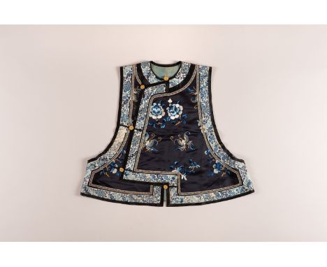 AN EMBROIDERED SILK XIAPEI, QINGChina, Qing dynasty (1644-1912), 19th century. The waistcoat is finely embroidered to each si