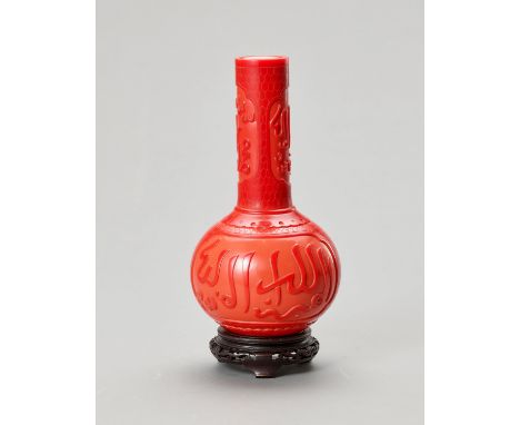A RED PEKING GLASS BOTTLE VASE FOR THE ISLAMIC MARKETChina, 20th century. The globular body and tall neck are carved through 
