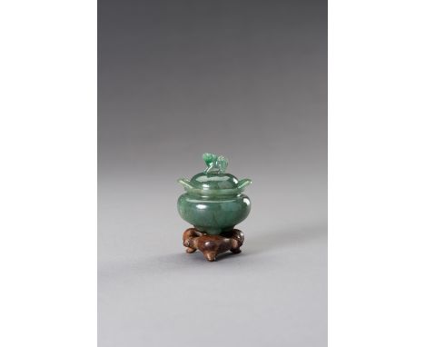 A MINIATURE GREEN HARDSTONE TRIPOD CENSER AND COVERChina, Republic period (1912-1949). The compressed globular body supported