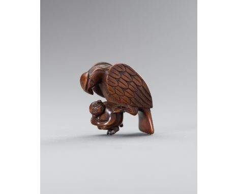 A BOXWOOD 'EAGLE SNATCHING MONKEY' NETSUKEUnsignedJapan, 19th century, Meiji period (1868-1912)Carved as an eagle snatching a