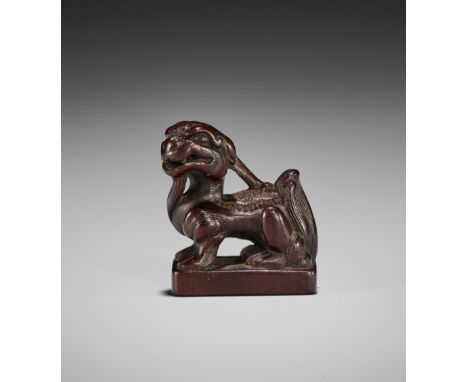 A RARE WOOD NETSUKE OF A SUISEIJapan, late 18th- early 19th century, Edo period (1615-1868)Finely carved with a suisei seated
