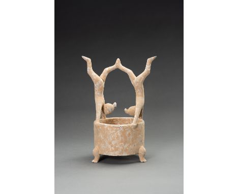 A POTTERY VESSEL WITH ACROBATS, HAN DYNASTYChina, Han dynasty (206 BC-220 AD). Modeled as two acrobats in handstand, holding 