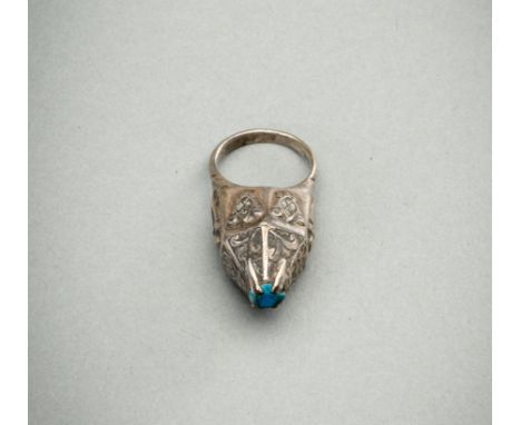 A TURQUOISE-MATRIX-SET SILVER RING, 19TH CENTURYIndia / Persia, 19th century. The silver ring with a cone shaped bezel, surmo