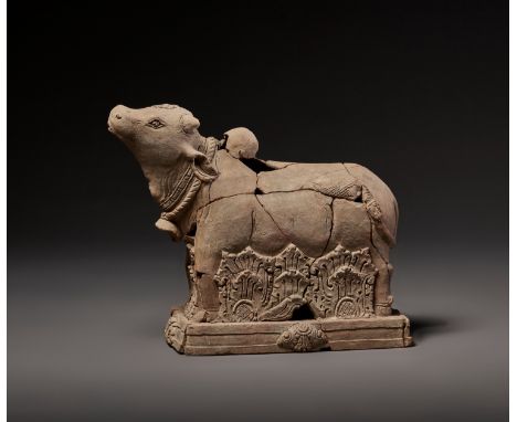 A TERRACOTTA FIGURE OF NANDI, MAJAPAHITEast Java, 13th-15th century. The divine bull standing foursquare on a rectangular pli