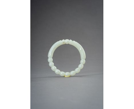 A PALE CELADON 'DRAGON' JADE BANGLE, 1930sChina, Republic period (1912-1949). Carved as confronting dragon heads flanking a c