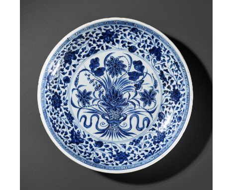 A MING-STYLE BLUE AND WHITE 'LOTUS BOUQUET' DISH, 18TH CENTURYChina. The rounded sides rising from a foot ring to a thick lip