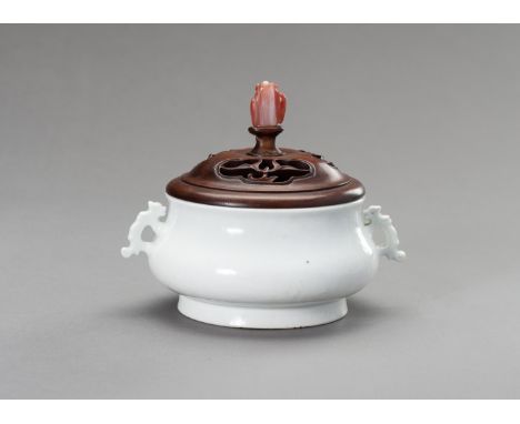 A DEHUA WHITE GLAZE PORCELAIN BOMBE-FORM CENSER, QINGChina, Qing dynasty (1644-1912). The compressed globular body applied wi