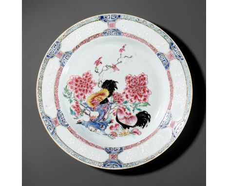 A FAMILLE ROSE 'DOUBLE COCKEREL' DISH, YONGZHENG PERIODChina, 1723-1735. Painted to the center with a pair of cockerels, one 