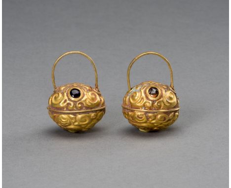 A PAIR OF CHAM GOLD REPOUSSE 'KIRTHIMUKHA MASK' EARRINGSCham kingdom, 10th-12th century. The upper half of the berry-shaped e
