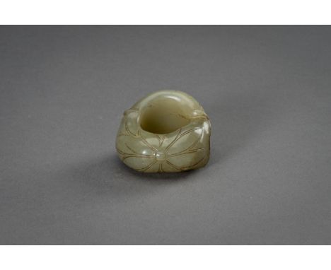 A CELADON JADE THUMB RING, 1900sChina, late Qing dynasty (1644-1912) to Republic period (1912-1949). Carved and incised on th