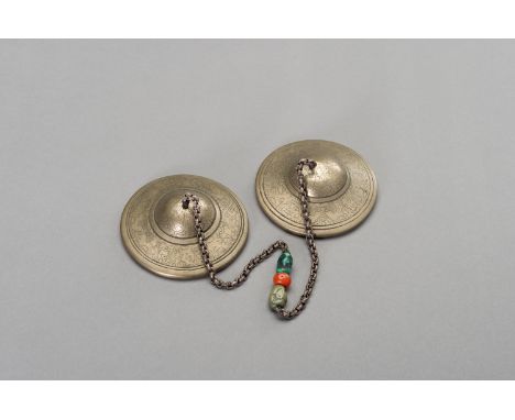 A PAIR OF TIBETAN RITUAL CYMBALS, 1900sTibet, late 19th - early 20th century. The two sacred cymbals of thick brass, finely i