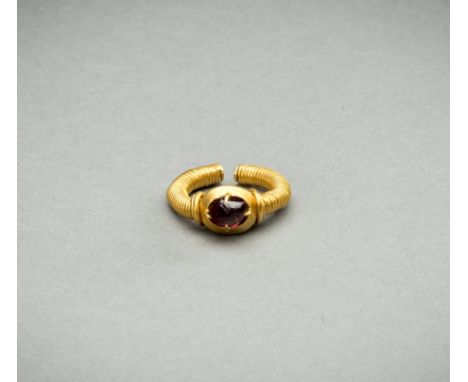 A GEMSTONE-SET GOLD RINGBurma/Myanmar region, Mandalay period (1853-1948). The gold ring consisting of two adjustable arms of