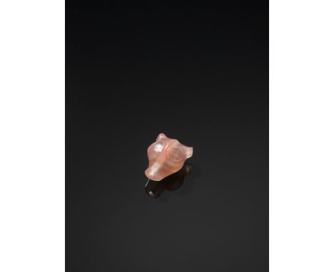 AN AGATE 'BEAST HEAD' TALISMAN, QINGChina, 1644-1912, or earlier. The translucent stone of a pale pink color with cloudy whit