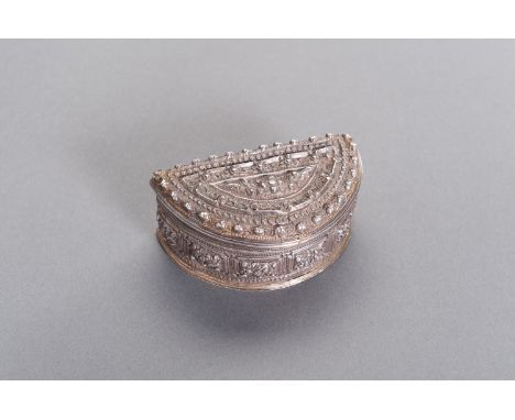A LIDDED SILVER BOXBurma/Myanmar 19th century. The semi-circular box with hinged lid is embossed and engraved all over with o