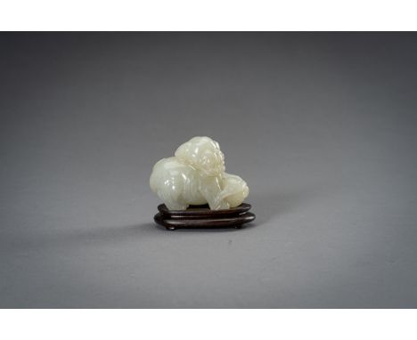 A PALE CELADON JADE FIGURE OF A BUDDHIST LION, 1930sChina, Republic period (1912-1949). Carved as a Buddhist lion, the mouth 