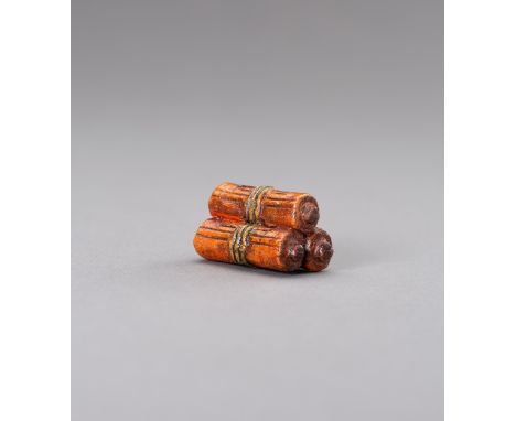 A YAKIMONO CERAMIC NETSUKE OF BUDDHIST SUTRA SCROLLSJapan, 19th centuryThe yakimono netsuke modeled as a pile of three Buddhi