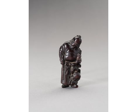 A WOOD NETSUKE OF SHOKI AND ONISigned  Japan, Edo period (1615-1868), 18th centuryCarved as Shoki, the demon queller, standin