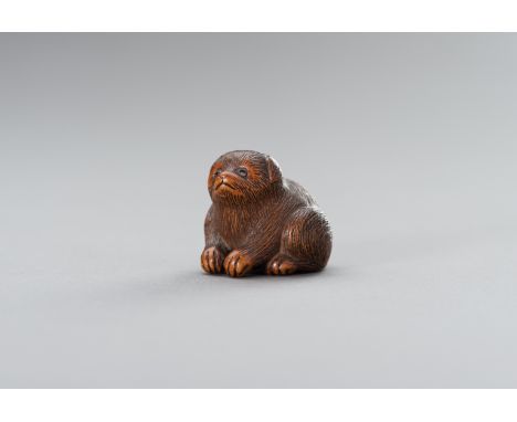 RIMU: A WOOD NETSUKE OF A PUPPYBy Rimu, signed RimuJapan, Iwami province, 19th centuryCarved as a puppy with an incised fur c