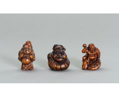 A GROUP OF THREE WOOD NETSUKE OF HOTEI AND DARUMAJapan, 19th century to Meiji period (1868-1912)The first depicting Hotei car