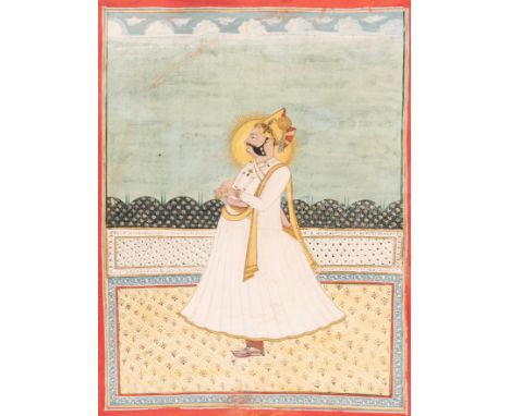 AN INDIAN MINIATURE PAINTING OF A RULERIndia, early 19th century. Watercolors, gouache and gold on paper. Standing on a terra