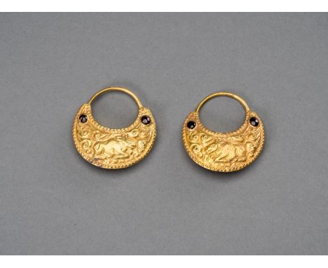 A PAIR OF CHAM GOLD REPOUSSE CRESCENT EARRINGSCham kingdom, 10th to 12th century. Shaped as a crescent, depicting Nandi surro