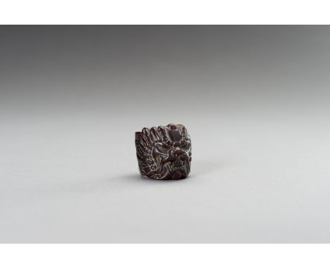 A CARVED 'BEAST' HORN RING, 1900sChina, late Qing dynasty (1644-1912) to Republic period (1912-1949). Carved as a mythical be