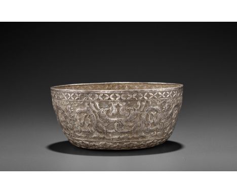 A VERY RARE AND FINE CHAM SILVER REPOUSSE BOWL WITH GARUDAS AND PHOENIXESChampa, 10th-12th century. The sides of the bowl fin