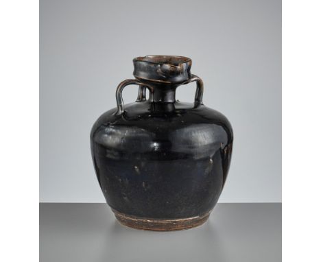 A CIZHOU BLACK-GLAZED EWER, SONG TO YUANChina, 960-1368. Of compressed globular form with a short neck and a wide circular mo