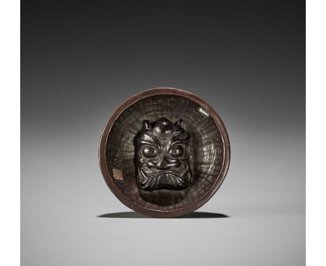 KOMIN: A RARE WOOD NETSUKE OF A DEMON MASK INSIDE SURIBACHIBy Komin, signed Komin 光珉 with sealJapan, Edo/Tokyo, late 19th cen