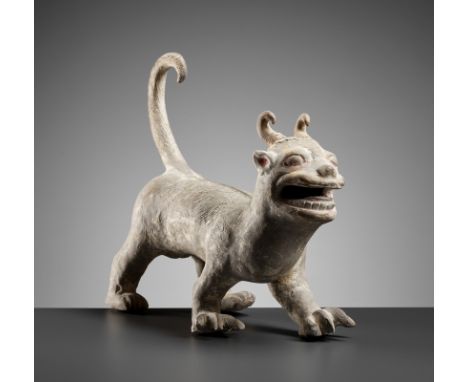 A PAINTED POTTERY FIGURE OF A MYTHICAL BEAST, LATE EASTERN HAN OR SLIGHTLY LATERChina, 2nd-4th century. The slender beast sta