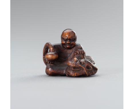 A SIGNED BOXWOOD NETSUKE OF RAKAN HANDAKASigned with a kakihanJapan, 19th century, Edo period (1615-1868)The rakan is shown s