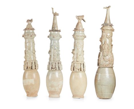 FOUR QINGBAI GLAZED FUNERARY URNS AND LIDSSONG DYNASTY each of ovoid form below a tall cylindrical neck surmounted by a garli